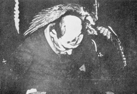 Photograph of Franek Kluski during a seance with the unexpected figure of a bird