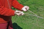 photograph of hands holding dowsing rods