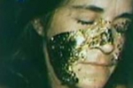 photo of Katie's face with gold leaf