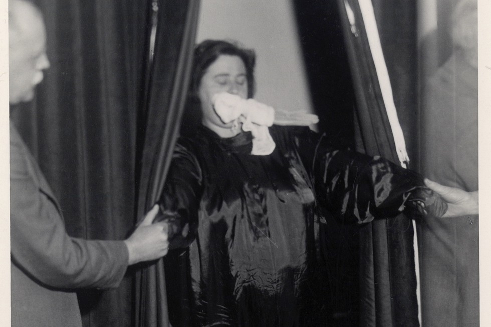 Above and below: Helen Duncan photographed in the act of producing 'ectoplasm' 